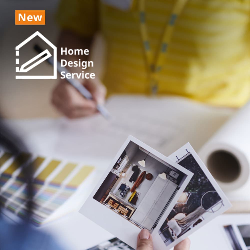 IKEA Home Design Service. IKEA co-worker in background in consultation with customer holding pictures of their new home. Find out more button.