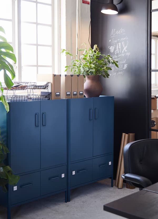IKEA IDÅSEN dark blue cabients with two drawers below on each unit.