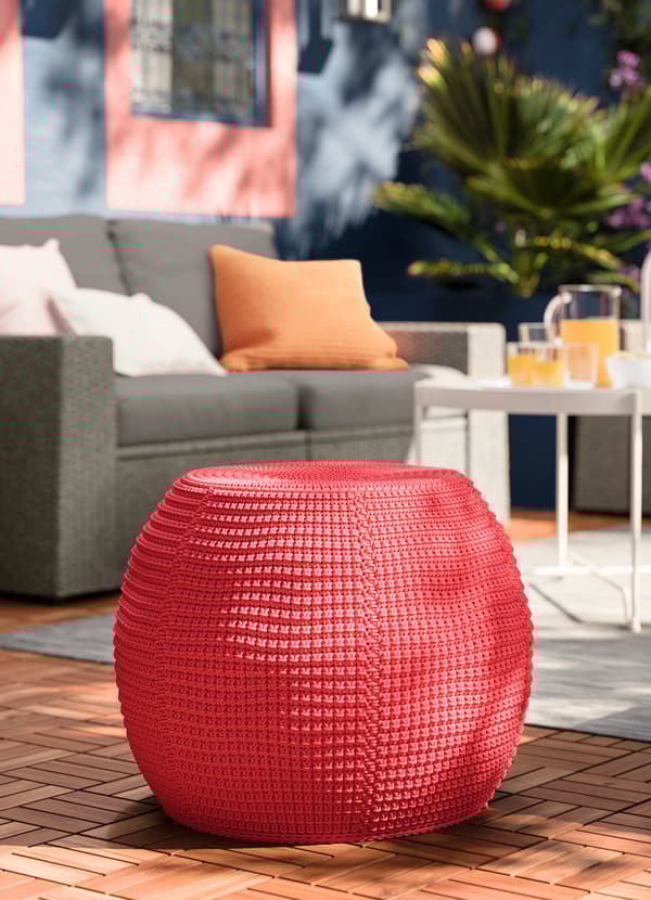 IKEA INNERSKÄR powder coated steel frame underneath a OTTERÖN crocheted red pouffe cover.