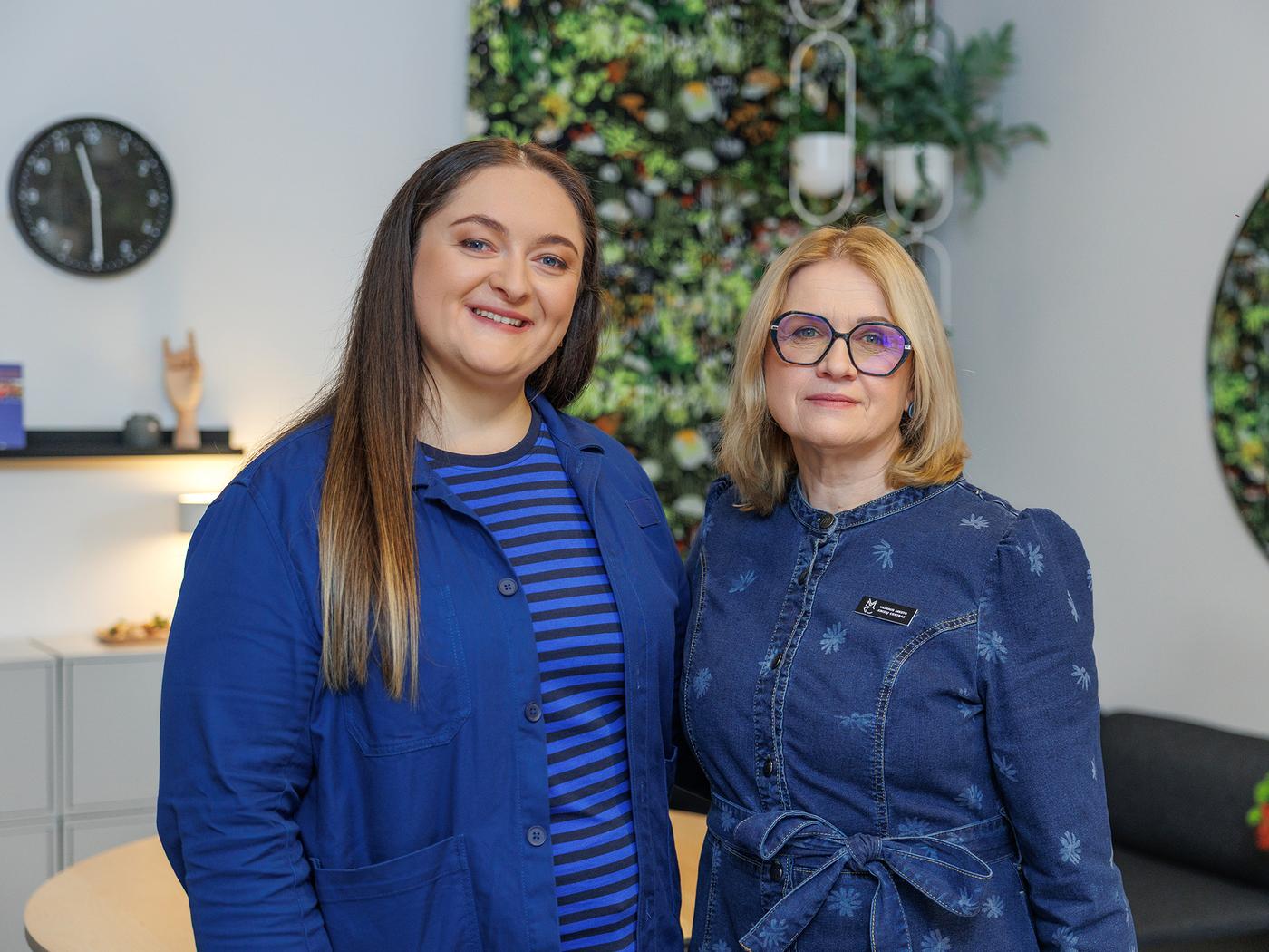 IKEA interior designer, wearing a blue uniform, stands next to the head of the Vilnius City Crisis Centre.