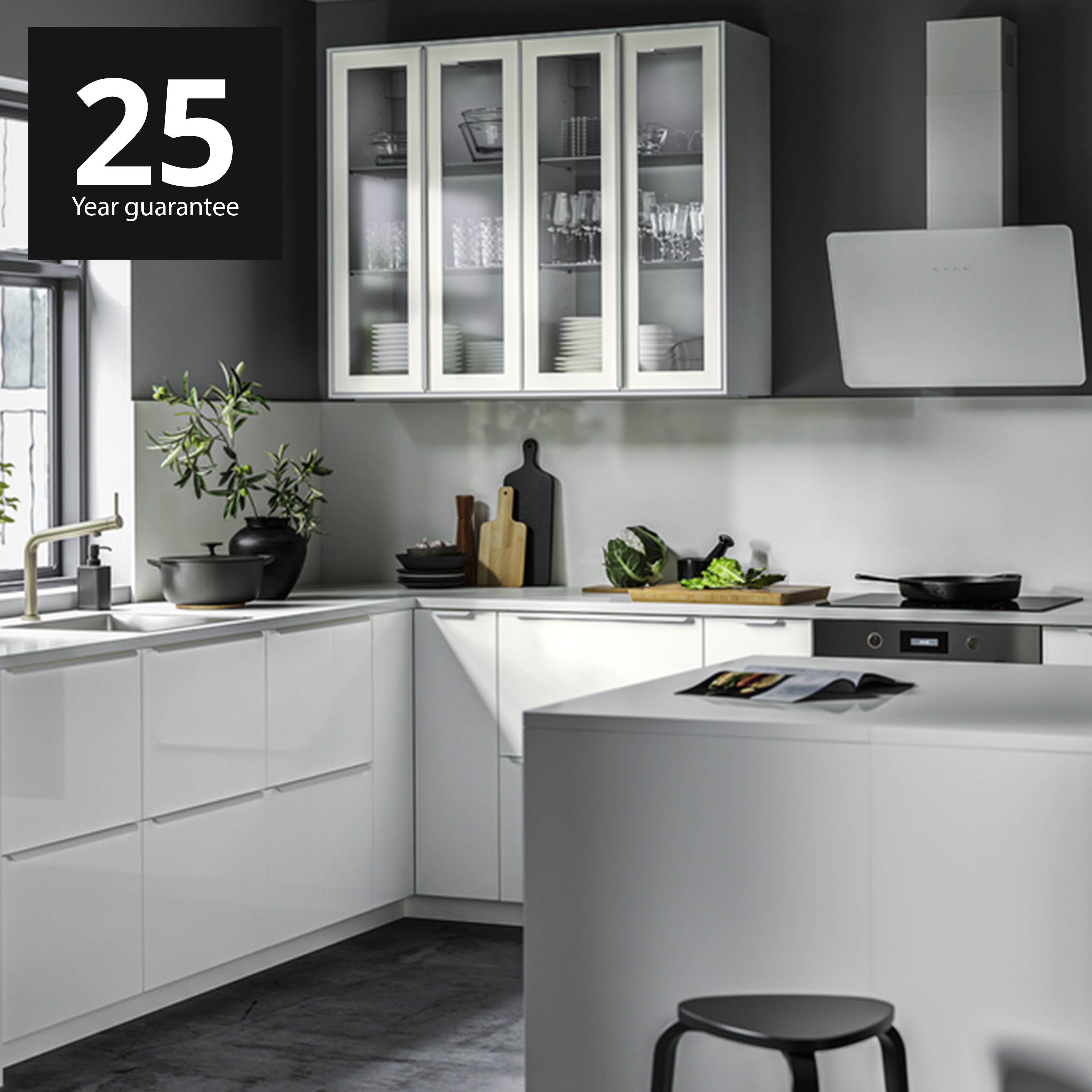 IKEA kitchen with METOD base cabinets and VOXTORP glossy white door fronts. 25-year guarantee logo at the top left corner of the thumbnail. 