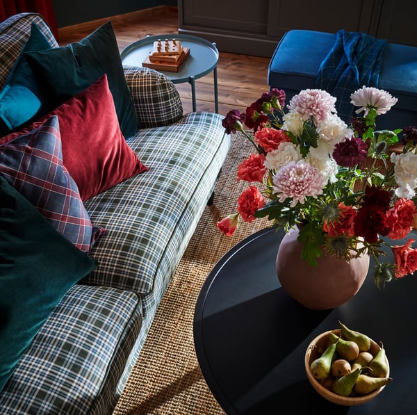 IKEA KRAGSTA black wood coffee table, handmade INDUSTRIELL brown terracotta vase and bright blue metal GLADOM tray table.