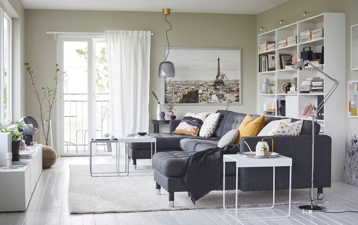 IKEA LANDSKRONA dark gunnared grey sofa seats five with two long lounge chaises. Steel chrome-plated legs add a modern touch to a living room.