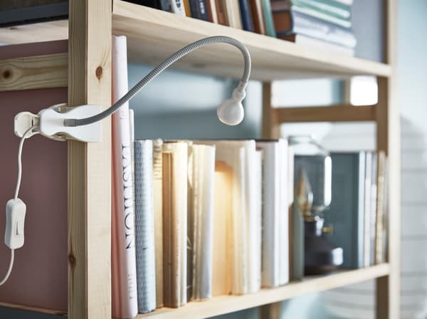 IKEA LED wall clamp spotlight lamp makes a smart lighting flexible task light since you can put it on bookshelves and ledges for greater visibility.