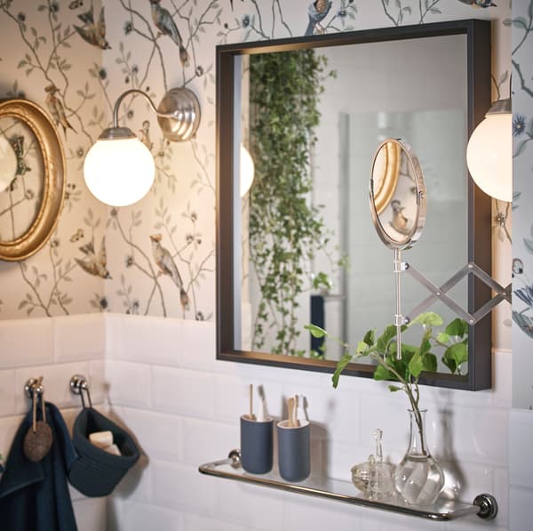 IKEA LILLHOLMEN nickel plated wall lamps emit a warm glow, while FRÄCK extendable mouted mirror has two different magnifications on each side of the glass so you can really see the details of your face.