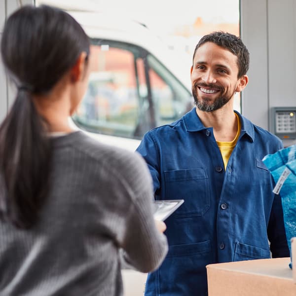IKEA-medarbejder leverer pakke til kunde. 