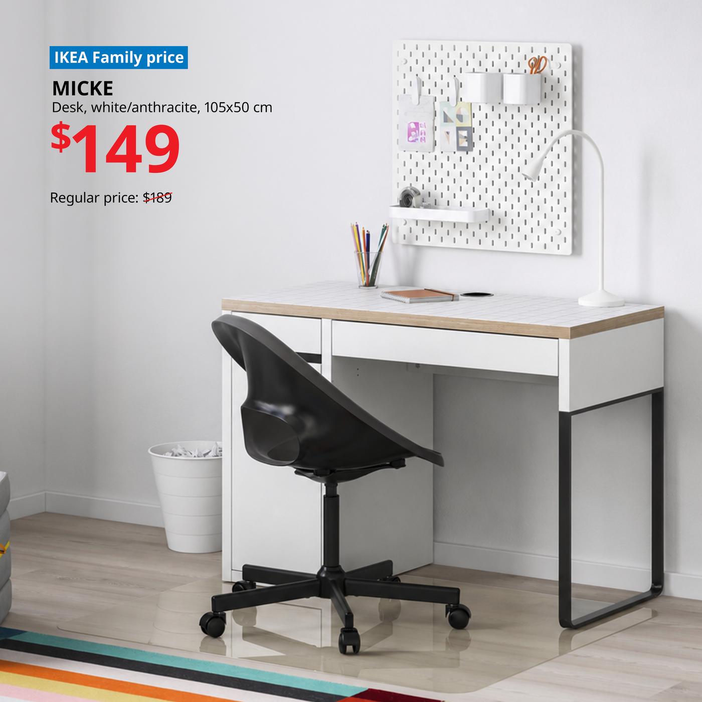 IKEA MICKE desk in white and anthracite, 105x50 cm, styled as a modern home office with pegboard organiser, desk lamp and black swivel chair. IKEA Family price $149, reduced from $189.