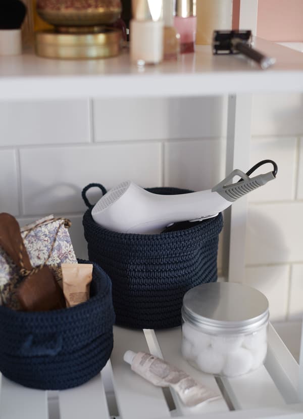 IKEA NORDRANA dark blue baskets are crocheted by hand, making each one unique. Store bulky items like hairdryers or smaller toiletries so they don’t get lost in the bathroom.
