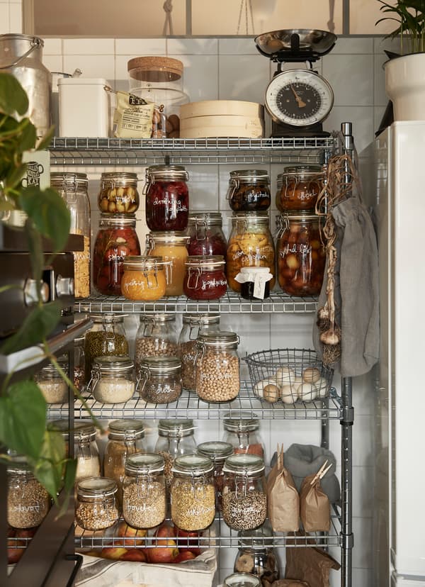 IKEA OMAR wire rack and IKEA KORKEN glass jars store food and cooking ingredients.