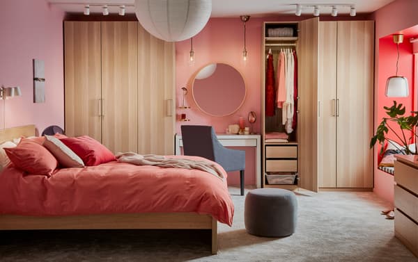 IKEA PAX/FORSAND wardrobe combination in white stained oak offers both hanging and folded storage, and NORRFLY LED lighting strip illuminates the wardrobe.