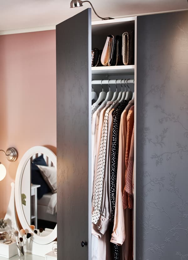 IKEA PAX white wardrobe comes with new dark grey floral patterned doors that can be illuminated under FORMAT LED nickel-plated cabinet lights. The door’s matte surface gives the delicate flowers a subtle, minimalist look and makes the relief pattern appear differently depending on how the light hits it.