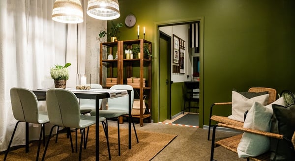 IKEA showroom setup for business customers with high tables, office chairs, and greenery décor