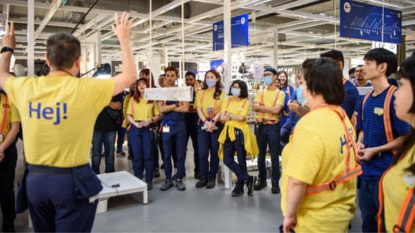IKEA Singapore co-workers gather in a circle for a briefing.