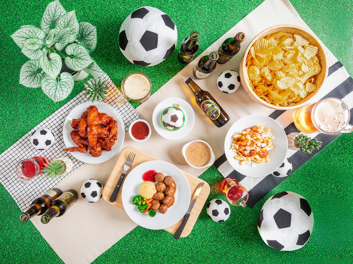 IKEA Singapore's Swedish Restaurant —a flat lay lifestyle shot featuring buffalo wings, nacho chips and meatballs celebrating World Cup, football fever