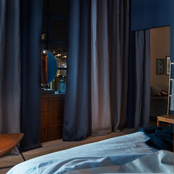 IKEA SONGESAND brown chest of 6 drawers, partially hidden behind AINA dark grey curtains and MAJGULL block out curtains.