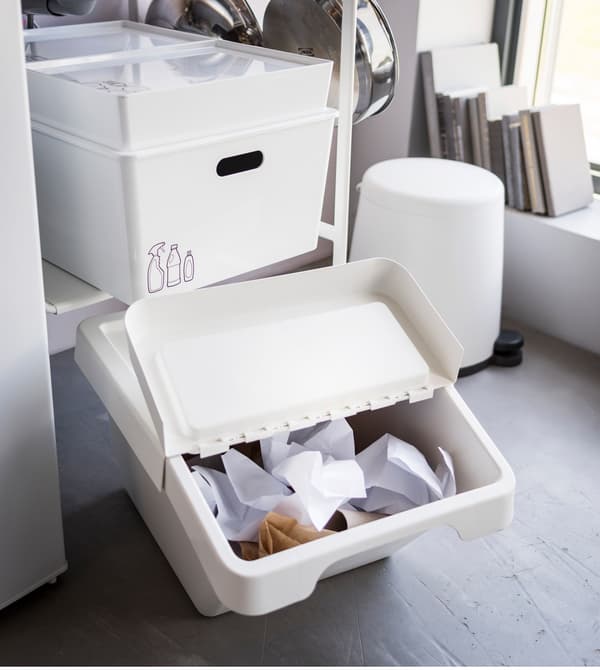 IKEA SORTERA white plastic waste bin with its foldable lid opened to throw away paper for easy access.