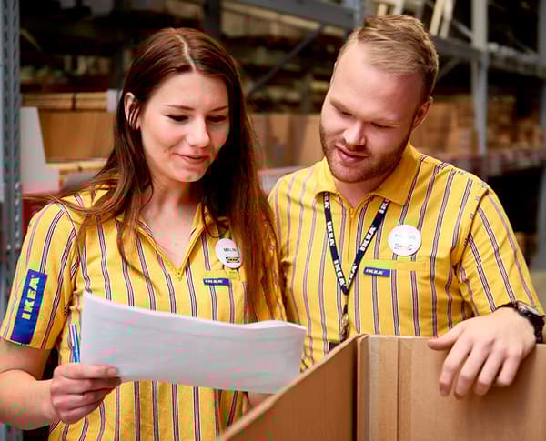 IKEA store co-workers, one man and one women, in similar work clothes, symbolizing our ambition for gender balance.