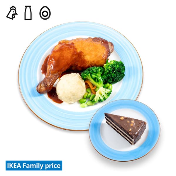 IKEA Tampines Halal Restaurant's IKEA Family offer — Smoked BBQ Chicken leg with mashed potato & mixed vegetables and a slice of chocolate hazelnut cake. Food allergen symbols of chicken, dairy and egg in black on the top left-hand.  The IKEA Family price tag is displayed in blue and white text, positioned at the bottom left of the image.