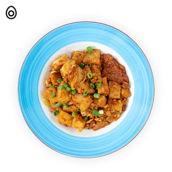 IKEA Tampines Halal Restaurant's weekend local breakfast — Fried carrot cake with an egg food symbol in black on the top left corner.