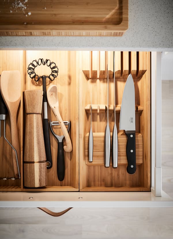 IKEA VARDGAGEN chef knives inside a kitchen drawer front with installed lighting.