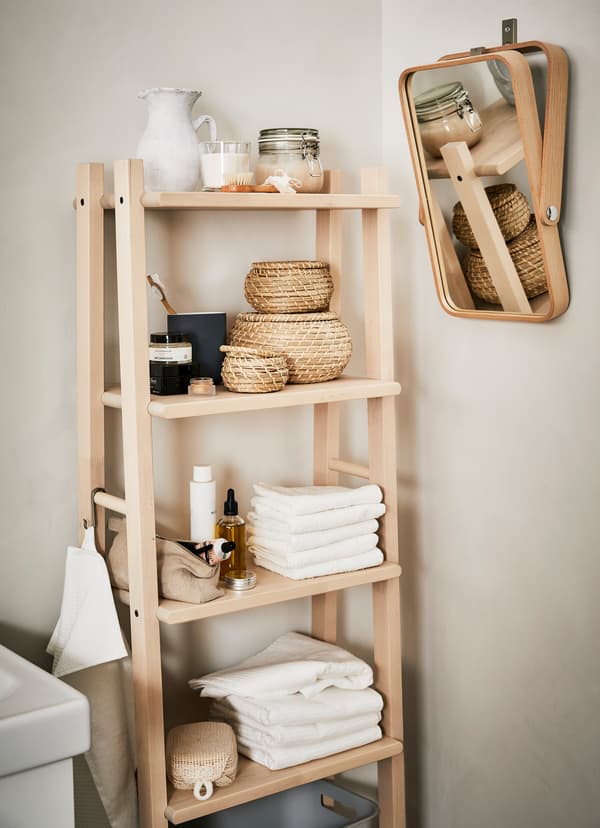IKEA VILTO towel stand crafted from fine-grained birch, holding bath towels and small woven baskets.