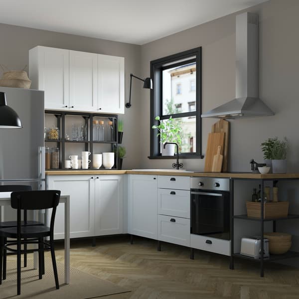 IKEA white shaker ENHET kitchen and wood worktop with a beige wall and wood floor