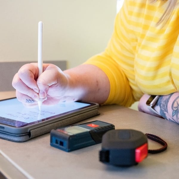 IKEA worker is taking notes on a tablet