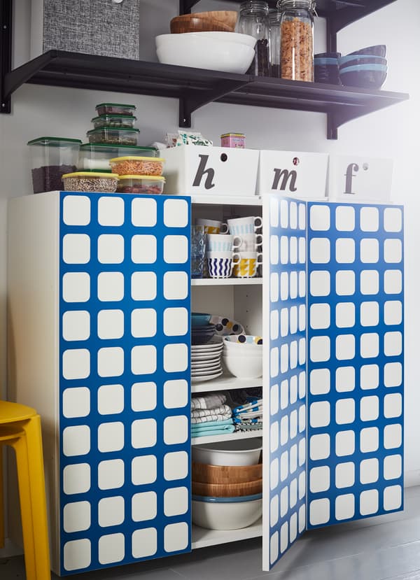 IKEA YTTERBYN kitchen cabinet door fronts come in bold colours and patterns designed by Swedish collective 10-gruppen. One pattern includes a bright blue grid pattern on a white base.