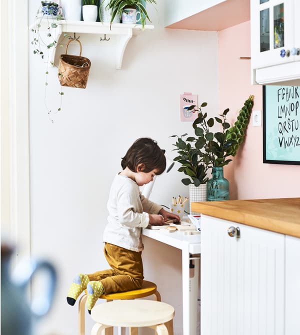 Ilaria’s son drawing at a desk in the kitchen.