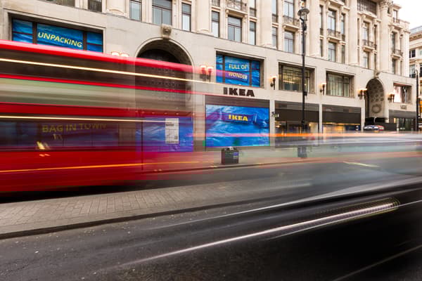 Image depicts blurred London bus driving past IKEA Oxford Street.