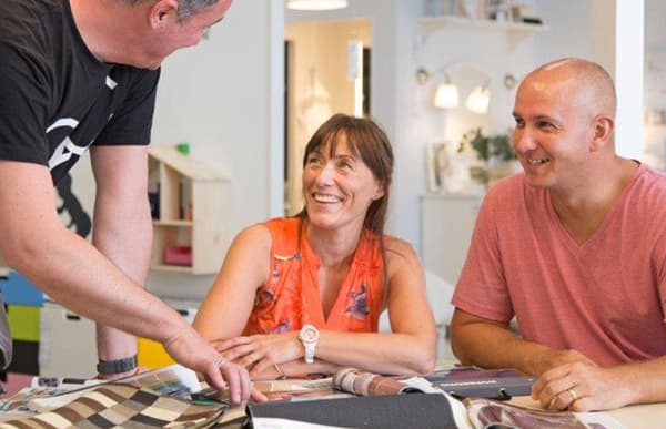 Image of a couple talking to someone showing a colour palette
