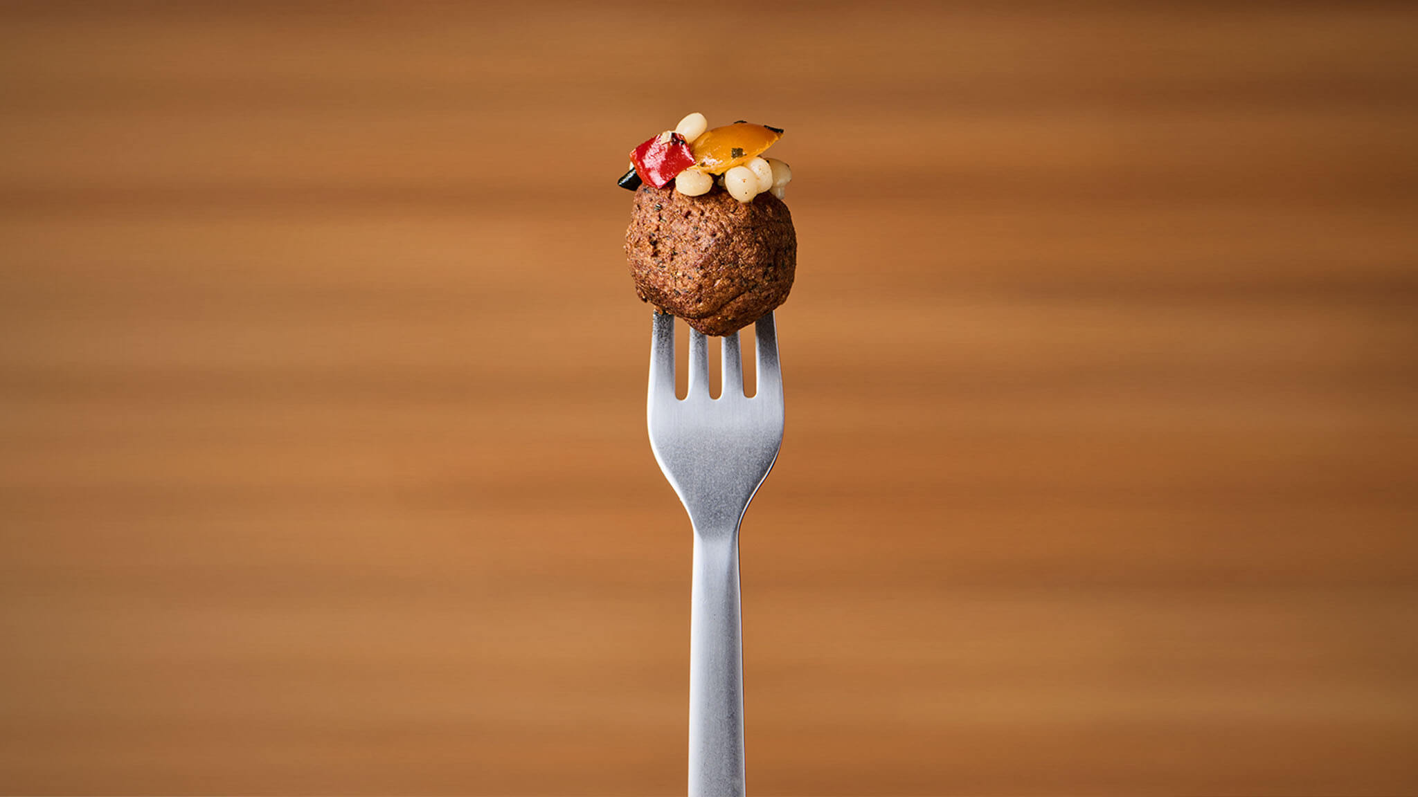 Image of a falafel ball on top of a fork