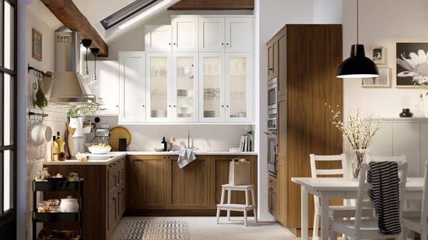 Image of a kitchen with white cabinets and brown wood cupboards.