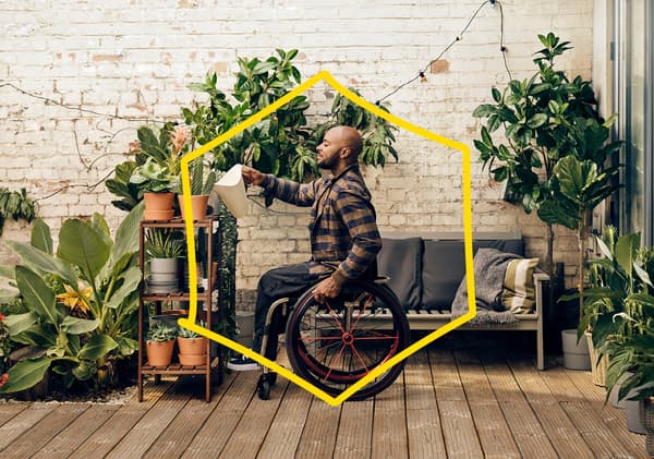 Image of a male in a wheelchair, watering plants