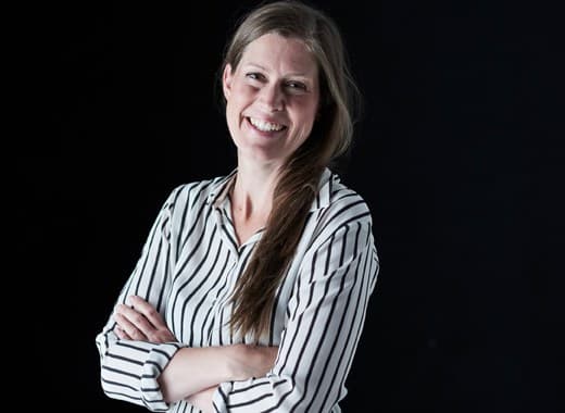 Image of a woman with her arms folded.