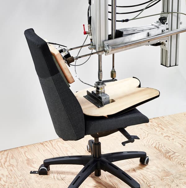 Image of an automated testing machine testing an office chair