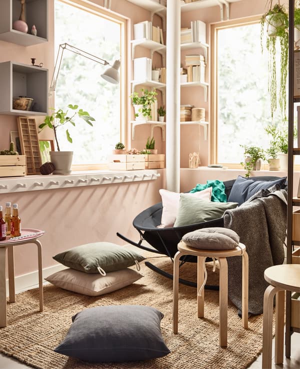 In a relaxing living room, low seating can be made from a mix of cushions, stackable stools and a bowl-shaped rocking chair from IKEA. The mix lets everyone choose how they like to sit. Don’t forget a rug, too, like LOHALS in flatwoven jute. 