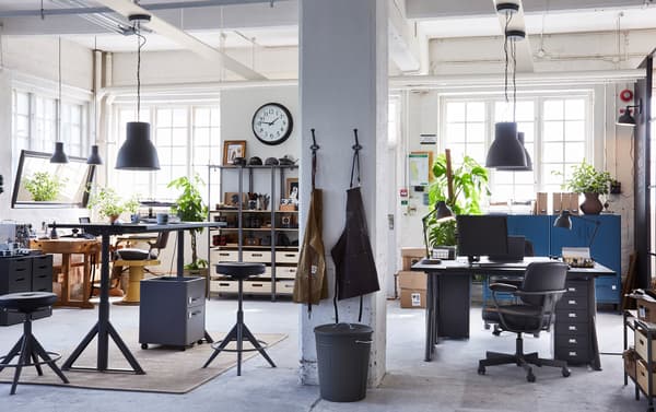 Industriële kapperszaak met IKEA IDÅSEN zwarte ladeblokken en VEBERÖD stellingkasten met accessoires.