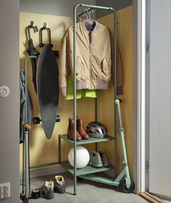 Ingresso con stand appendiabiti NIKKEBY con abiti appesi, scarpe e un casco. Attorno allo stand vari accessori per le attività all'aperto - IKEA