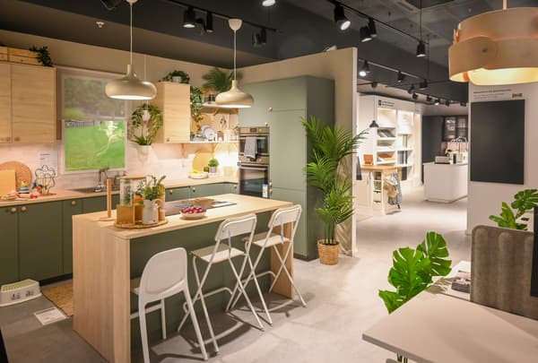 inside an IKEA Plan and Order Point. A green kitchen with a kitchen island