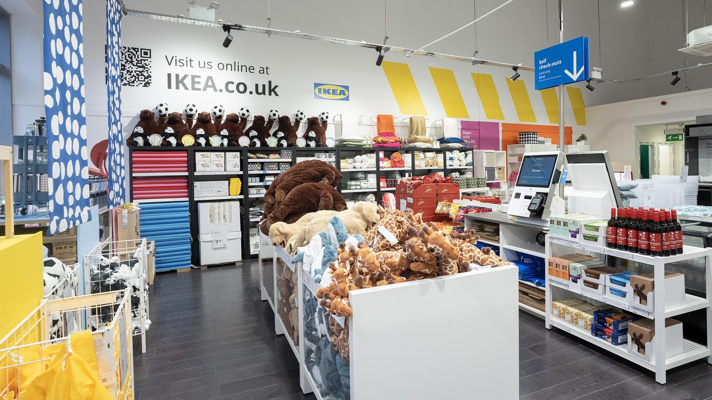 Inside the IKEA Banbridge store, showing IKEA products on shelves and in baskets with a till.