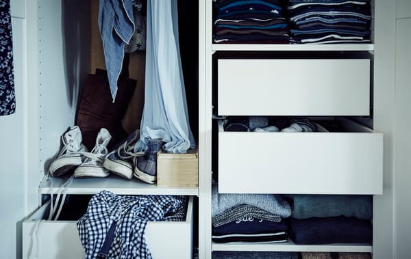 Intérieur d’une armoire avec tablettes, tiroirs et tringle.