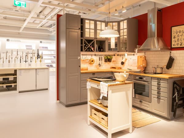 Interior view from the IKEA planning studio in Zurich showing a sample kitchen in a corner layout with kitchen island. 