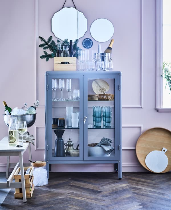 Invite your friends to a holiday potluck dinner in your living room. Create a ‘serving station’ for all the drinks. We went for a big ‘bar cabinet’ with glass doors. If you like it this one is called IKEA FABRIKÖR.