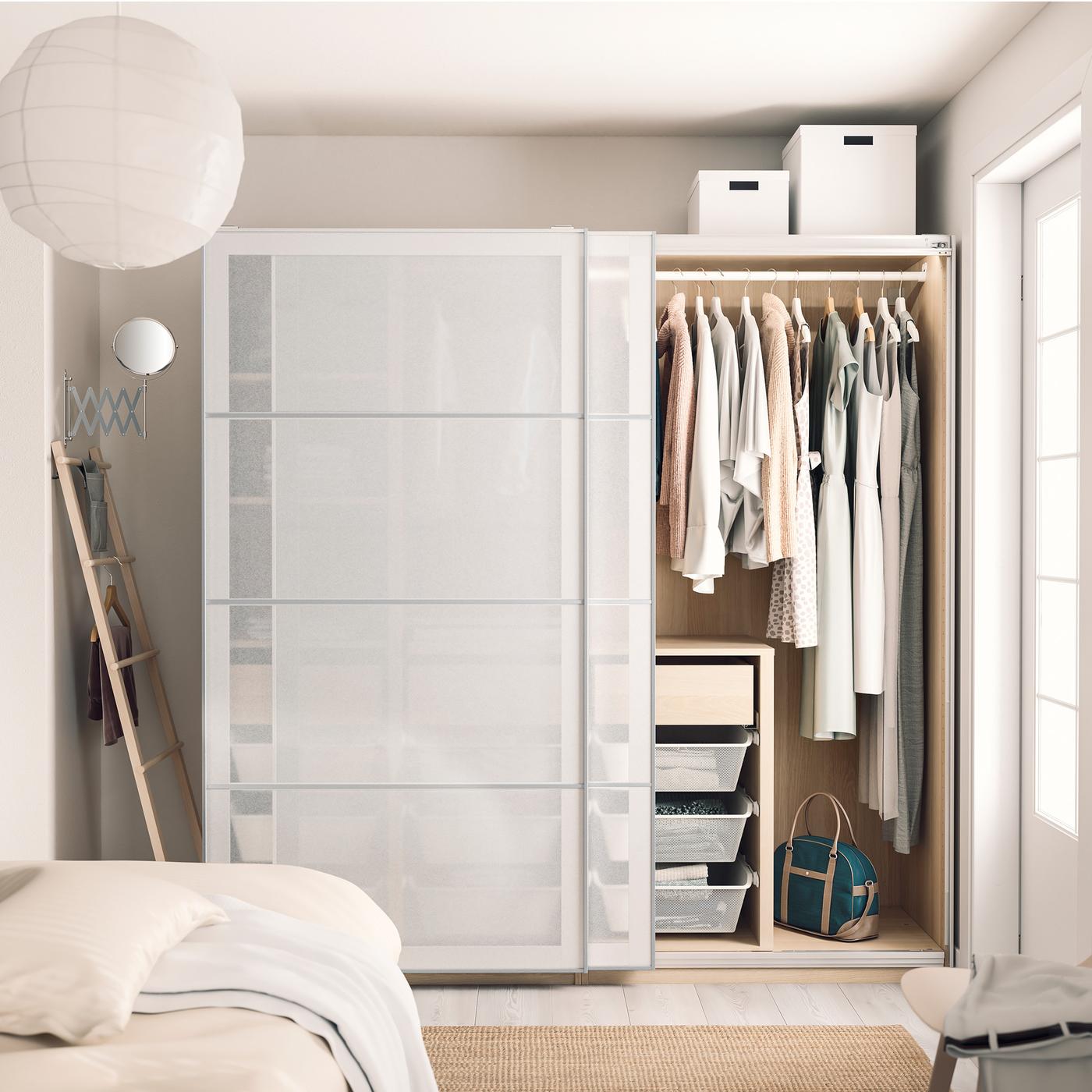 白いスライドドアのクローゼットが開いており、ハンガーに掛けた衣類と棚に収納ボックスやバッグが整然と並んでいる。