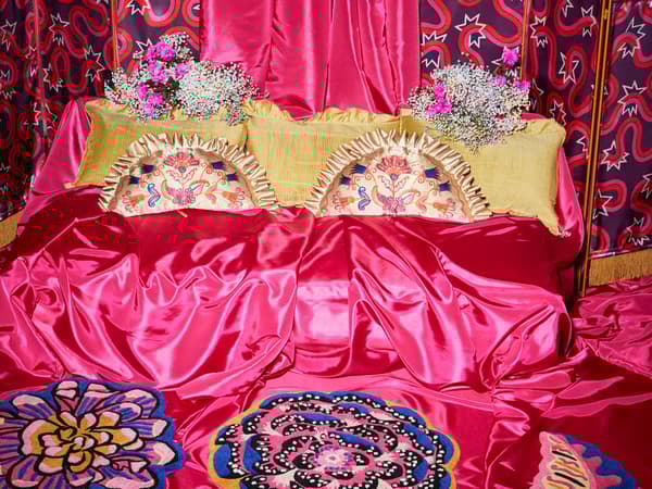 Items from the KARISMATISK collection on a bright pink background