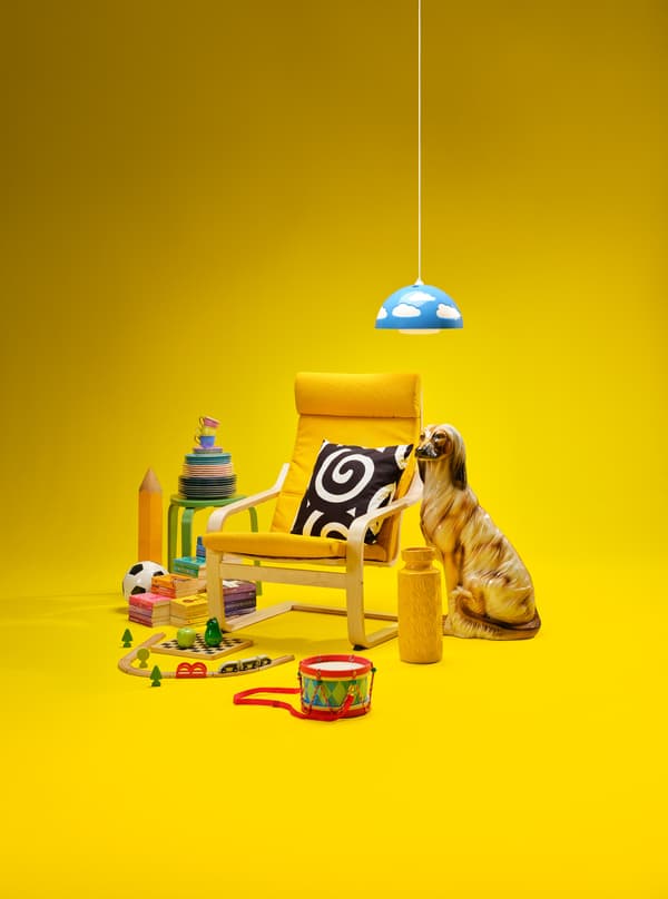 Items such as a chair, cushion, dog statue, hanging lamp, ... on a yellow background.