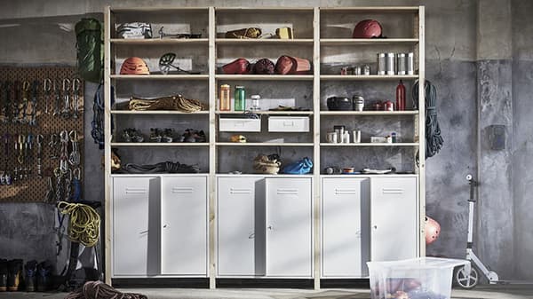 IVAR cabinets and shelves placed in a utility room, furnished with different tools and accessories.