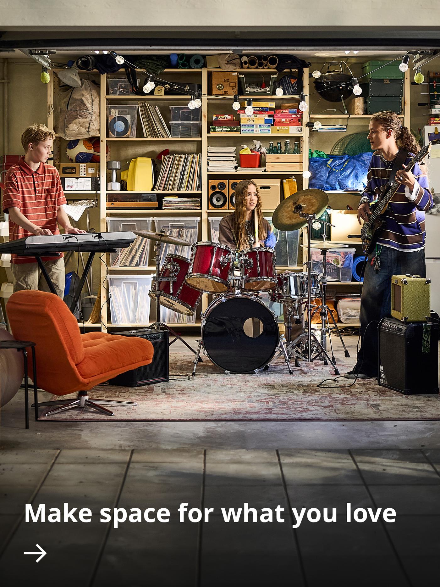 IVAR shelving units create organised storage in a garage where a band is practising with drums, guitars and keyboards.