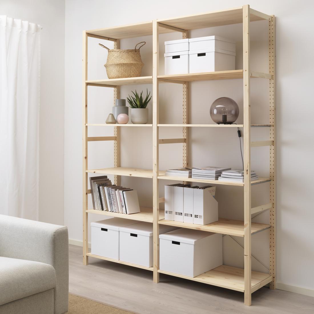 IVAR solid pine storage shelves in living room with multiple TJENA paper storage boxes and decorative items on the shelves. 